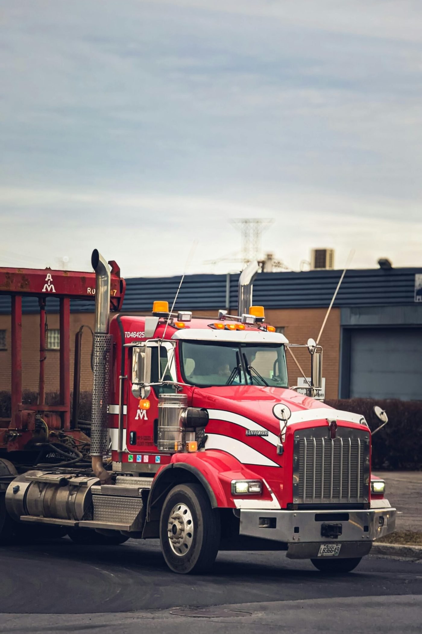 Vibrant red semi truck parked in an industrial area of Montreal, Canada.
